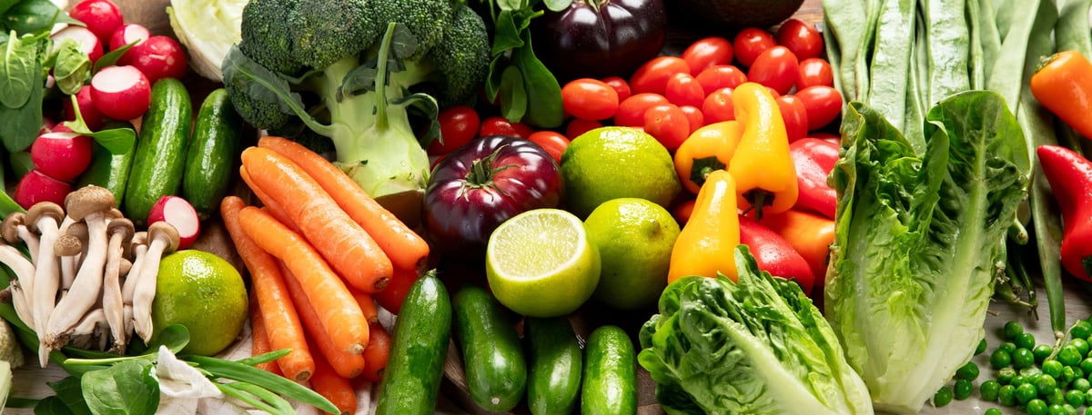 Organic fresh vegetables on a light background. Vegetarian, vegan concept. Top view. Panorama.